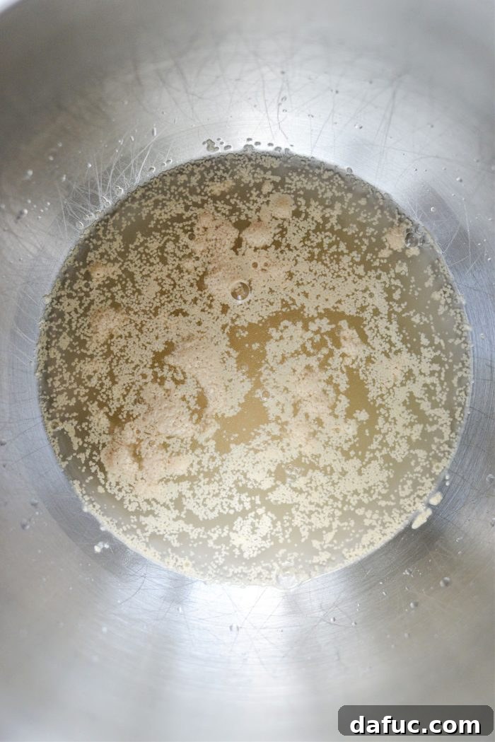 Bite-Sized Pita Pockets 4 Sugar, warm water, and active dry yeast preparing to be mixed in a stand mixer bowl