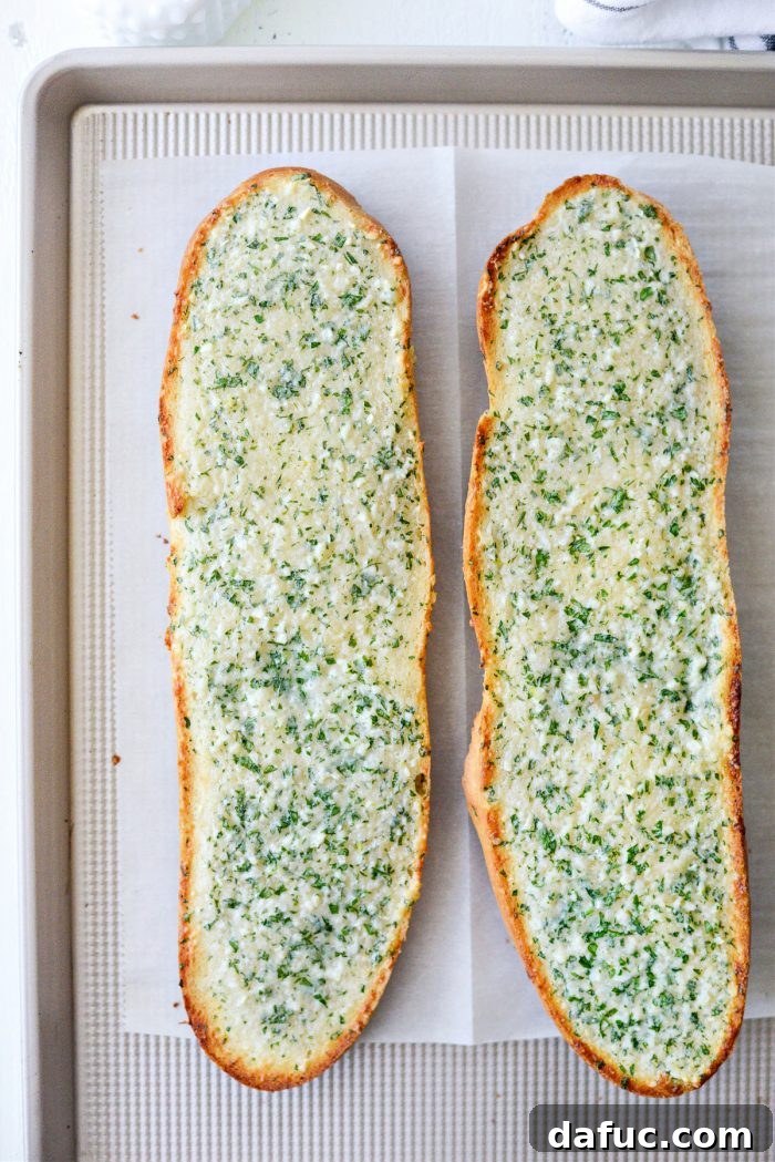 Freshly baked garlic bread, golden brown and crisp around the edges, just out of the oven