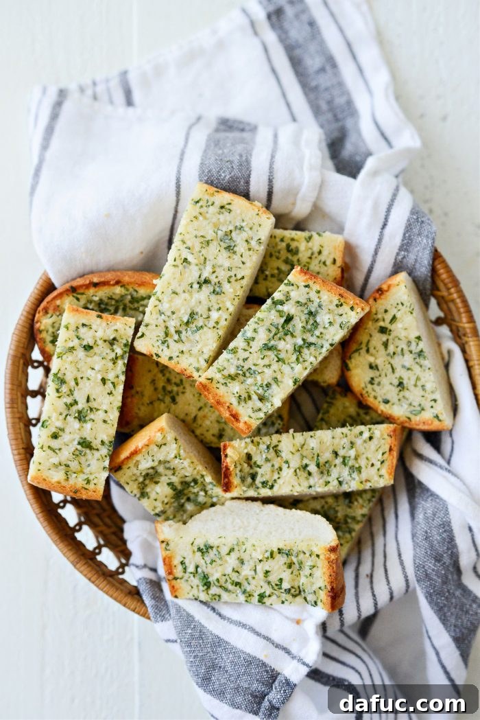 A platter brimming with freshly sliced 15-Minute Garlic Bread, ready for guests to enjoy