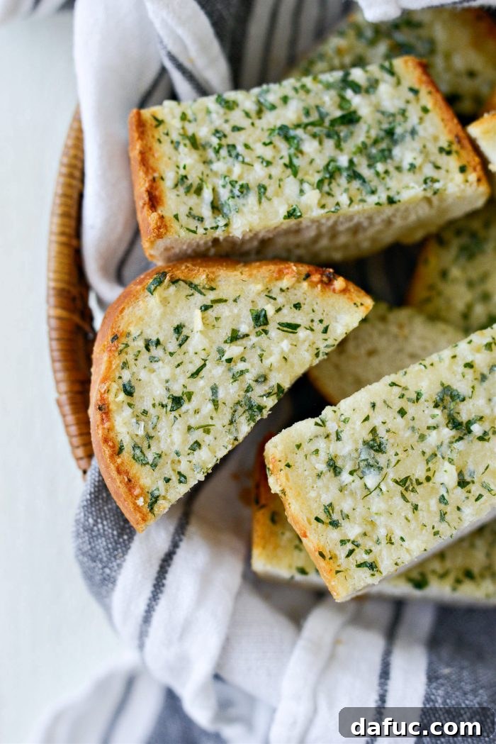 A full loaf of 15-Minute Garlic Bread, sliced and beautifully presented on a cutting board, ready to be served