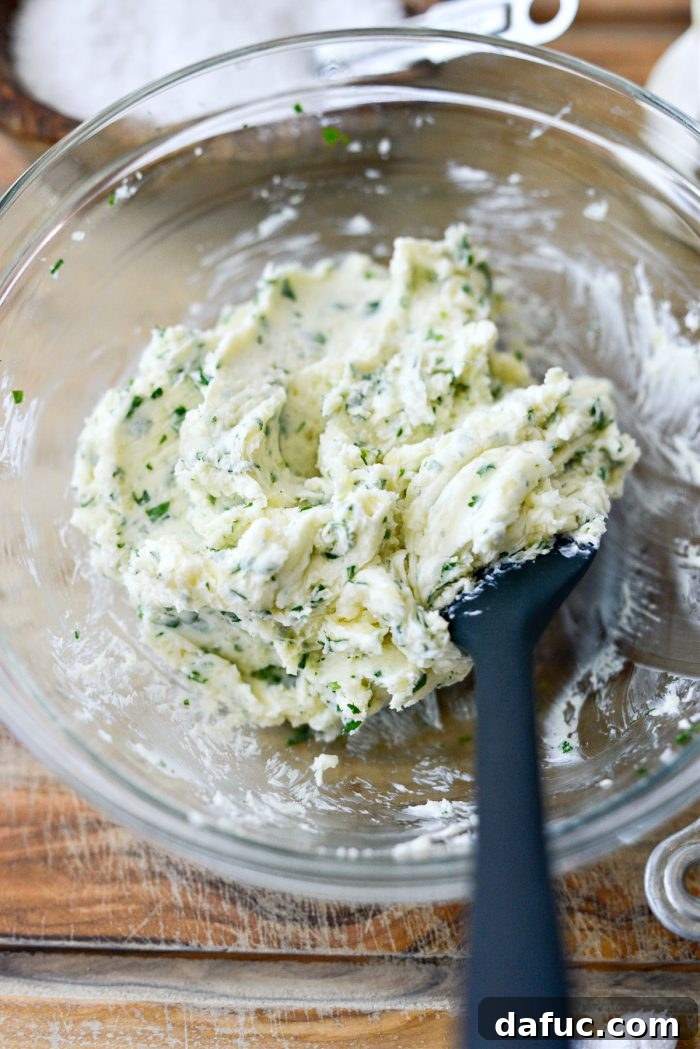 The finished parmesan garlic butter mixture in a bowl, smooth and evenly incorporated, ready to be spread