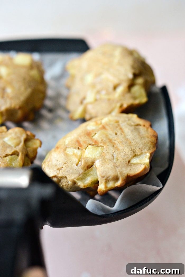 Guilt-Free Air Fryer Apple Fritters 14 Turning air fryer apple fritters over to finish cooking