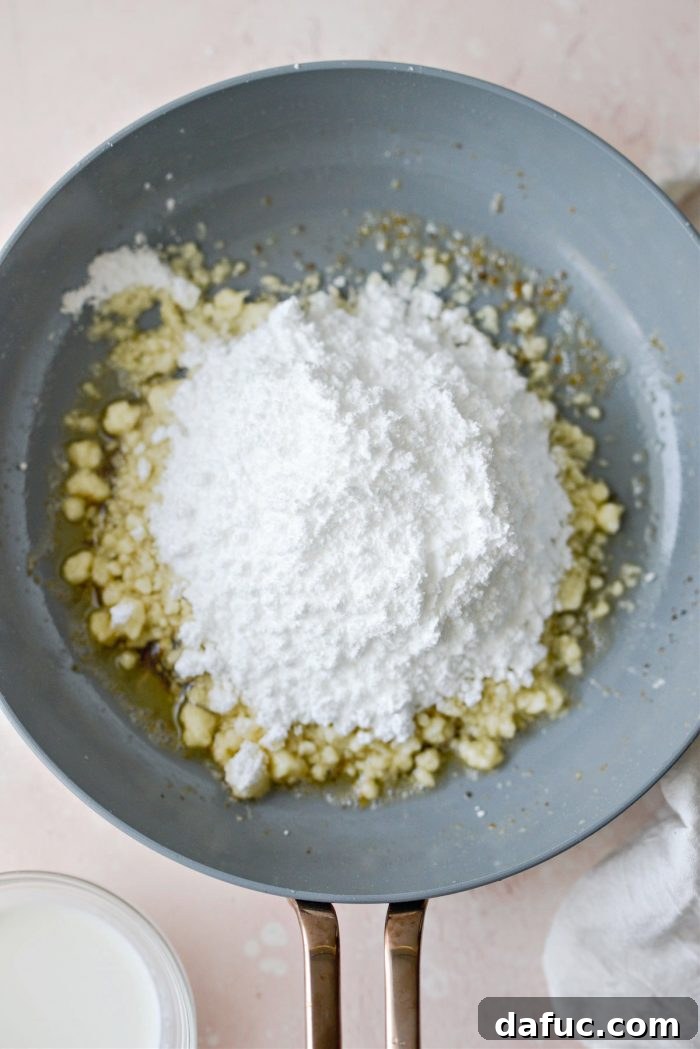 Guilt-Free Air Fryer Apple Fritters 17 Sifted powdered sugar added to the browned butter