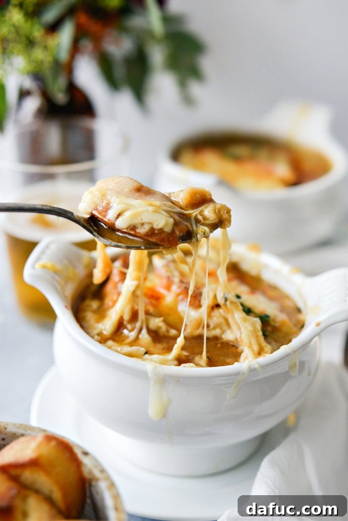 Smoky Beer French Onion Soup, a rich and comforting bowl topped with toasted bread and melted Gruyère cheese.