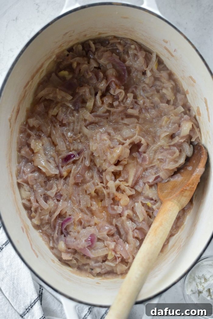 Fully softened and caramelized onions in a Dutch oven after 1 hour of cooking.