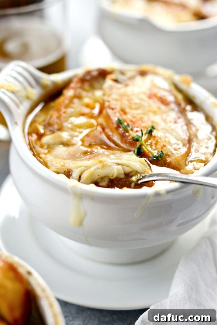 Smoky Beer French Onion Soup, a close-up showing the rich broth and melted cheese.