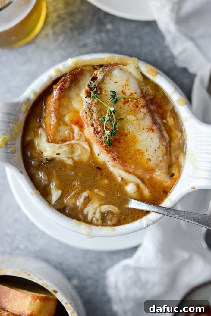 A final close-up shot of the steaming Smoky Beer French Onion Soup, topped with rich, melted cheese.