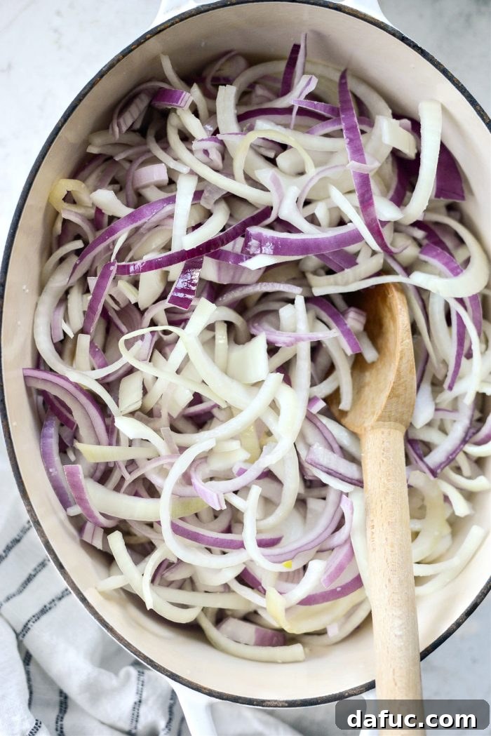 Onions thoroughly tossed in butter in a Dutch oven.