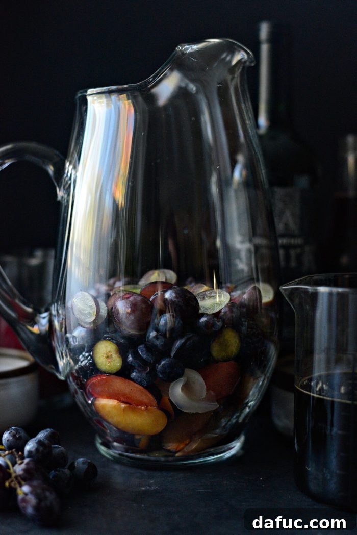 Assorted dark fruits in a large pitcher