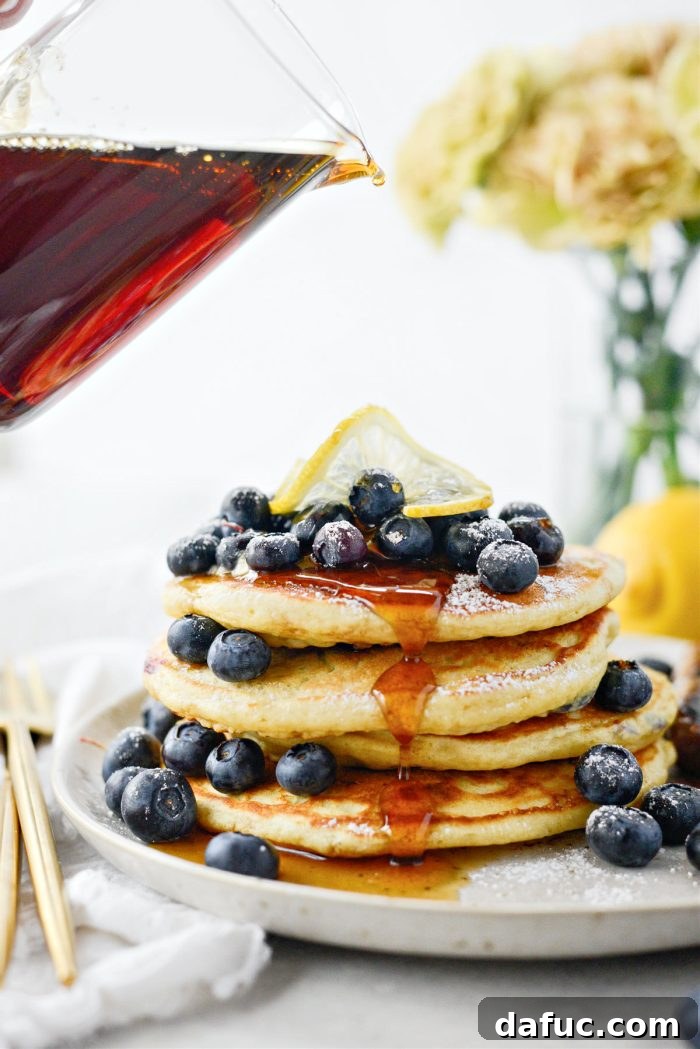 Bright Lemon Blueberry Pancakes 17 Lemon Blueberry Pancakes drizzled with maple syrup