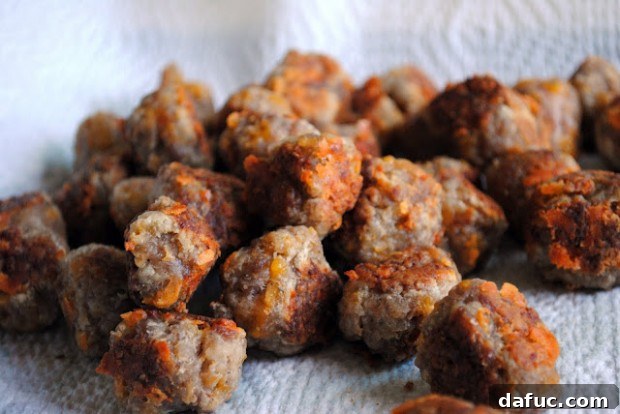 Cheesy Sausage Poppers 2 Delicious Sausage Cheese Balls ready to be served on a platter