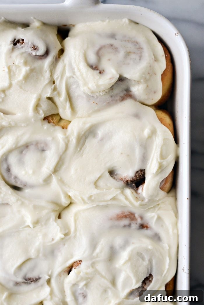 The Story of 2021 23 Close up of frosted cinnamon rolls, warm and inviting