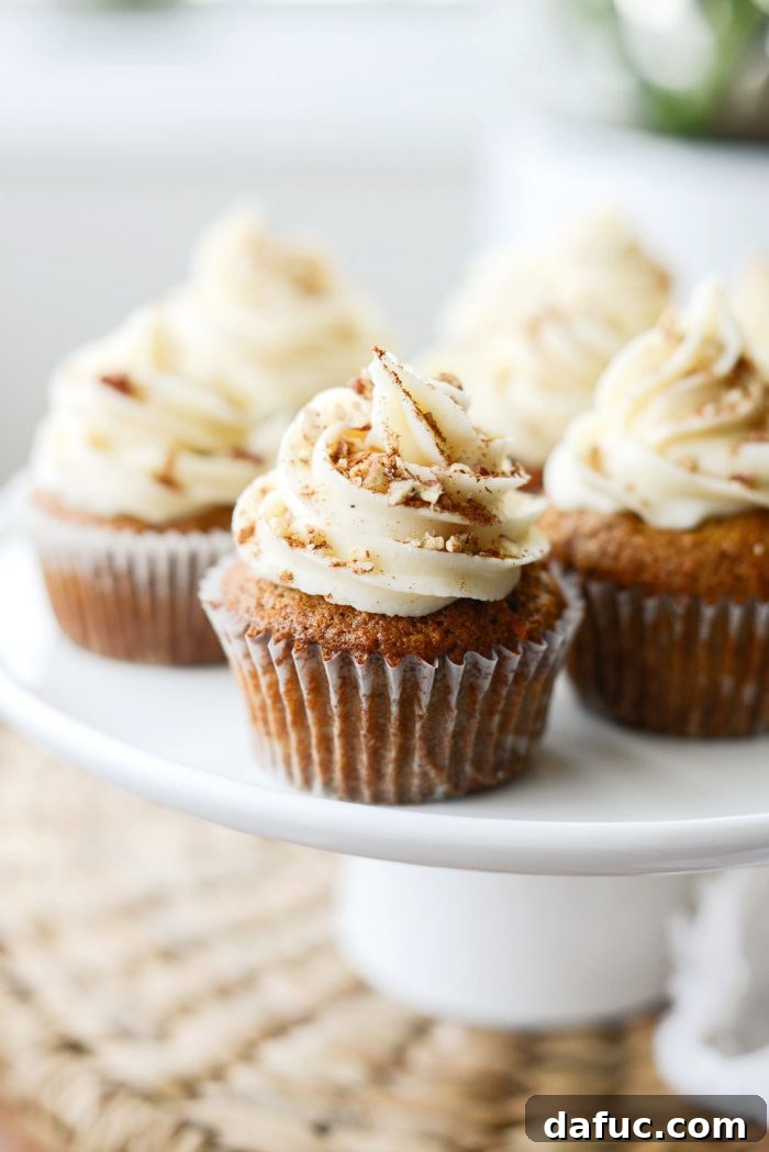 The Story of 2021 8 Decadent Carrot Cake Cupcakes topped with cream cheese frosting