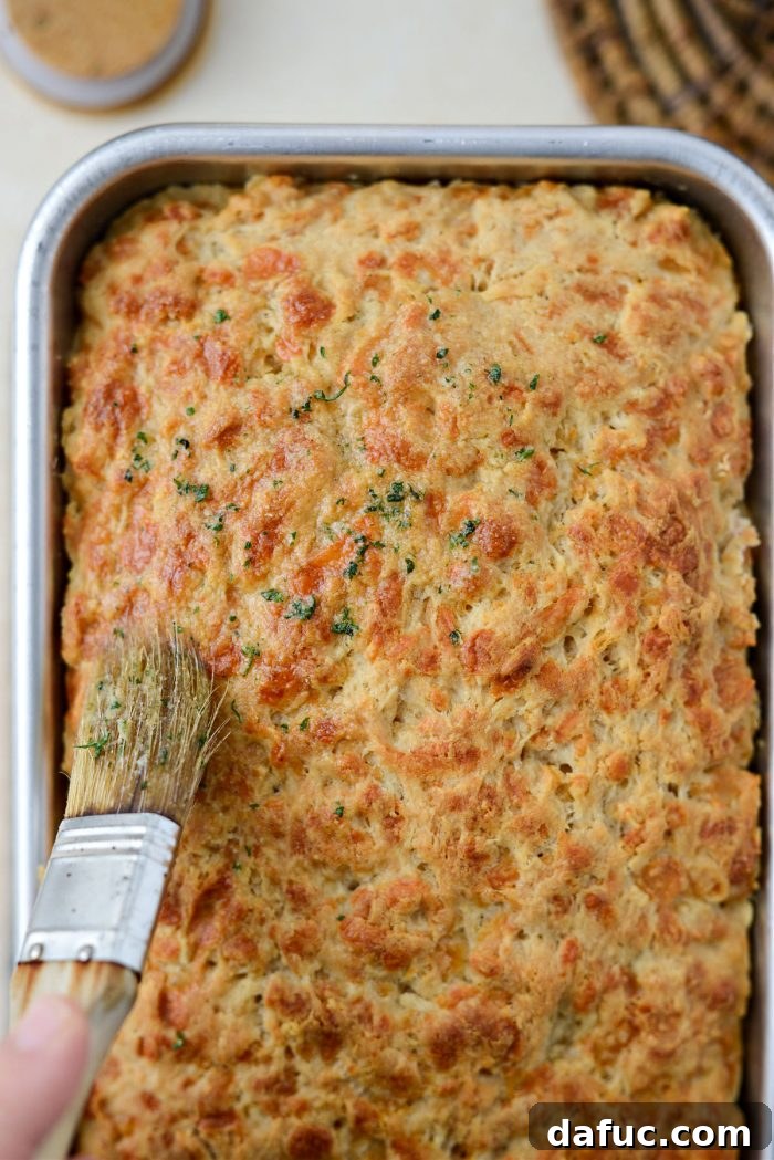 Brushing the top of the Irish Beer and Cheddar Bread loaf with garlic butter