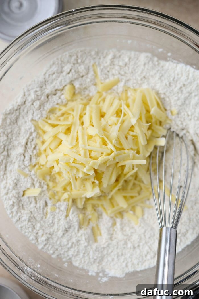 Adding shredded Irish cheddar to dry ingredients