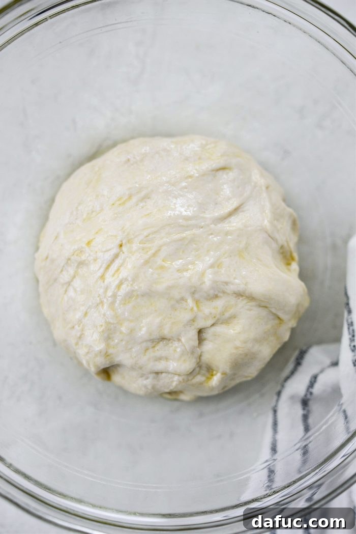 Shaping dough into a ball and coating with oil.