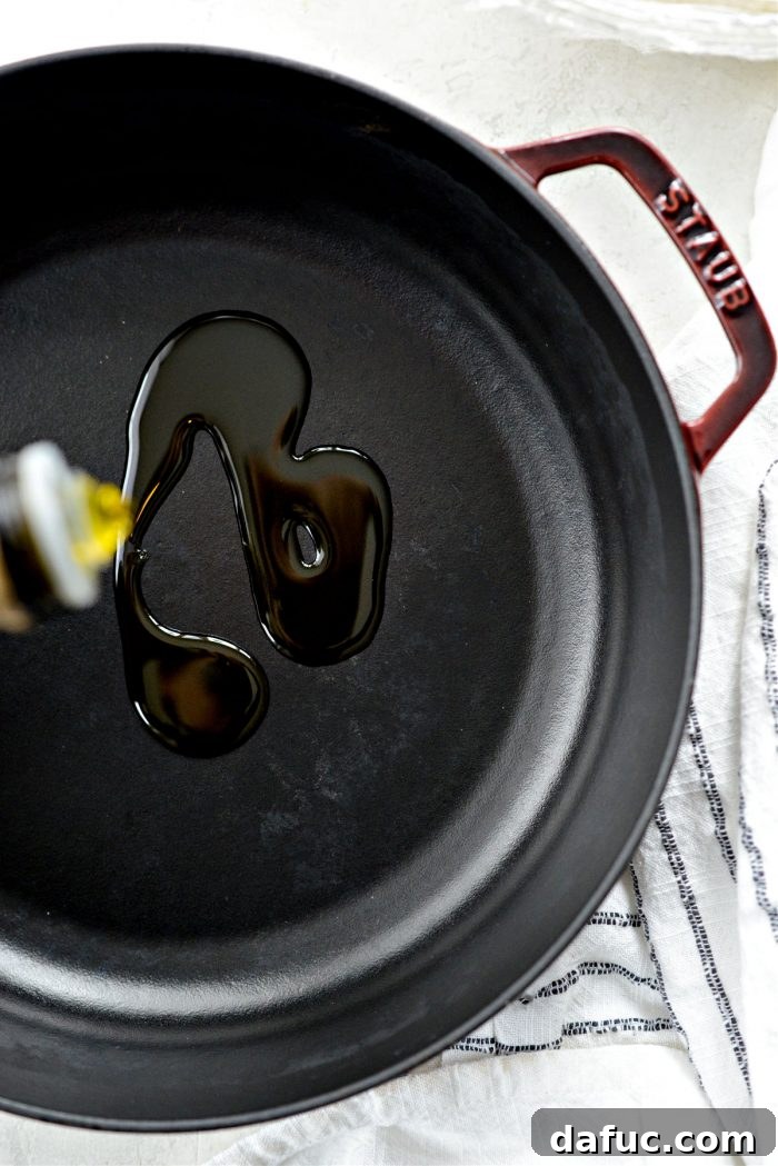 Generously oiling a baking pan.