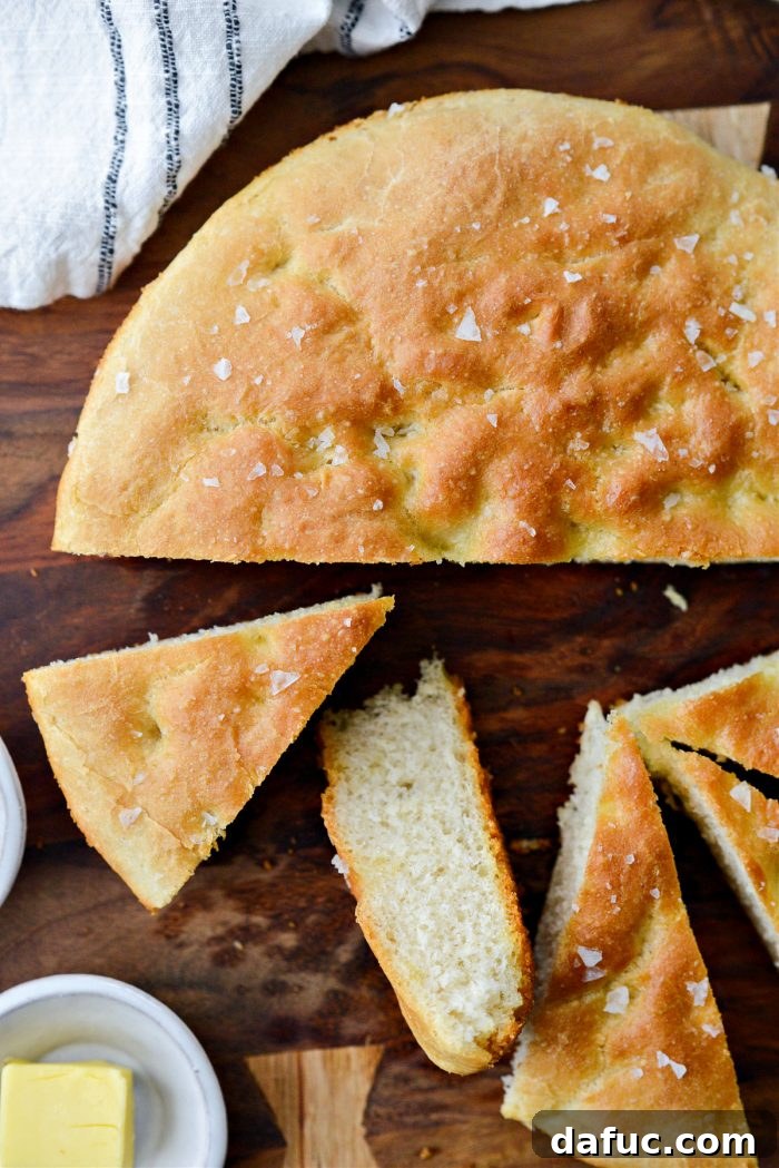 Slicing Homemade Focaccia and serving with butter.