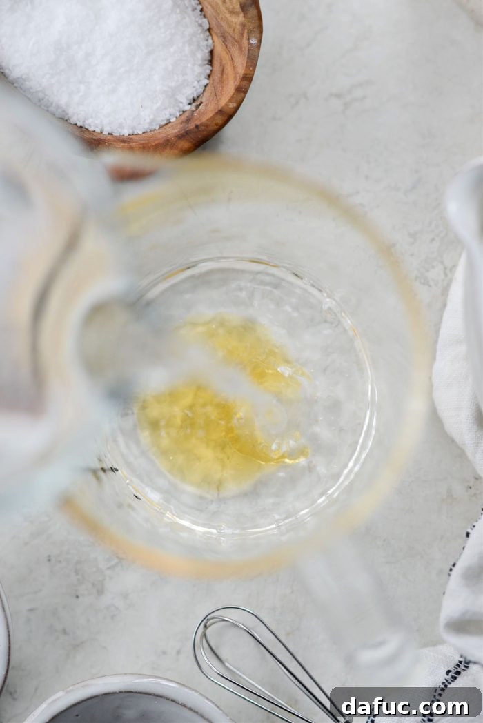 Adding warm water to the honey.