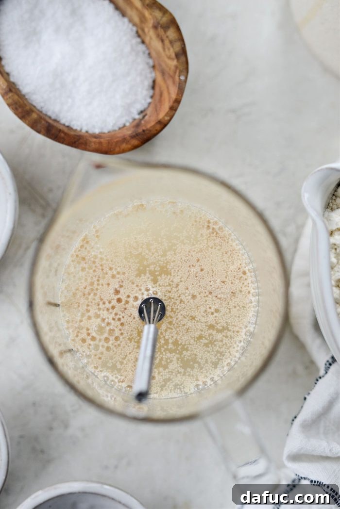 Adding active dry yeast and whisking.