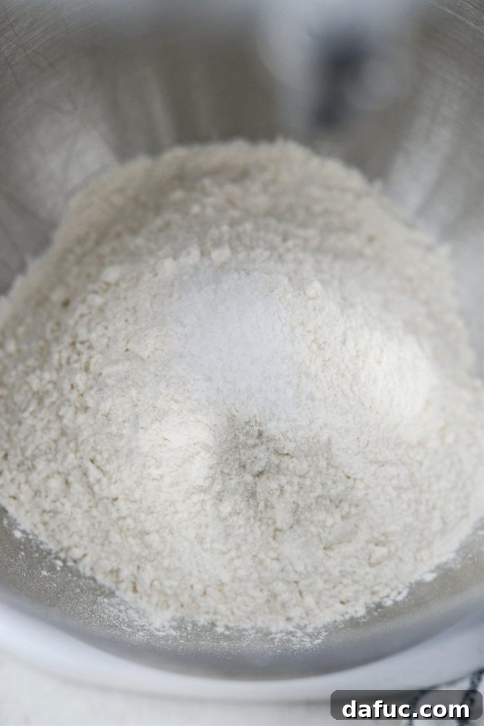 Combining flour and salt in a mixing bowl.