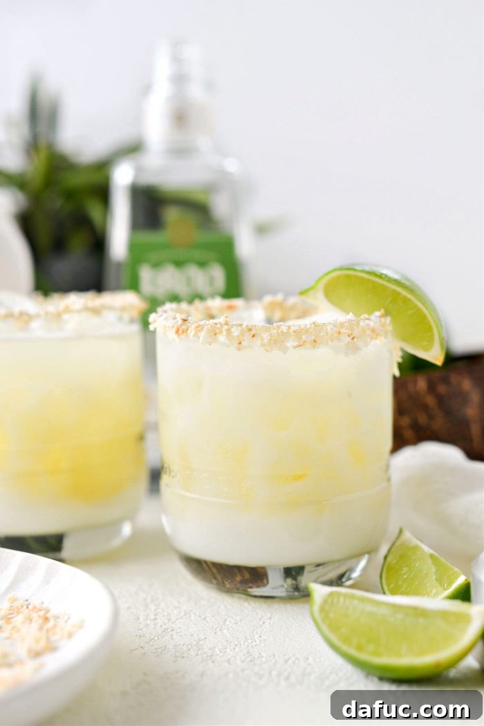 A freshly made Pina Colada Margarita, garnished with a lime wedge, ready to be enjoyed