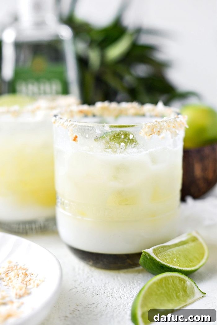 A half-sipped Pina Colada Margarita with a straw, showing the inviting layers of the drink