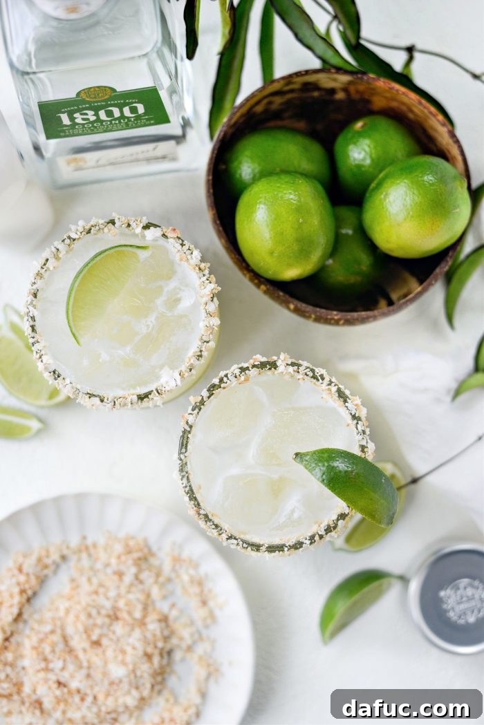 Close-up of a Pina Colada Margarita being poured, highlighting the creamy texture and tropical colors