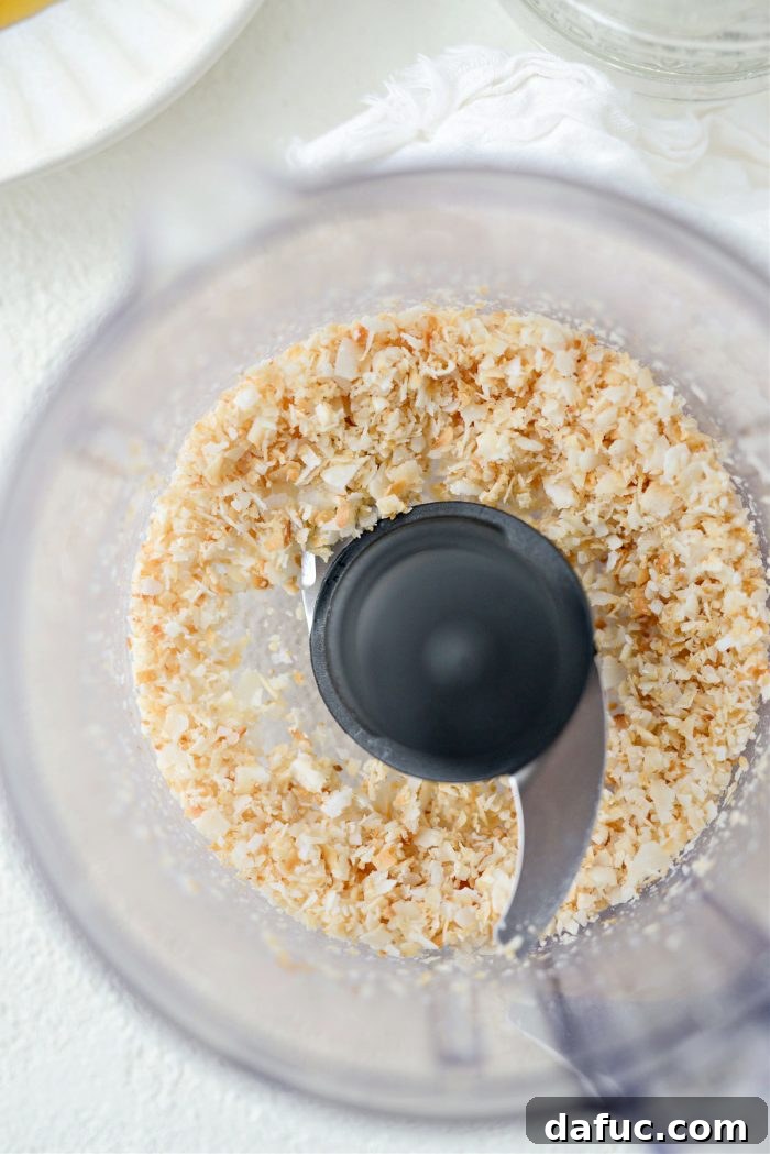 Finely ground toasted coconut in a mini food processor after being pulsed