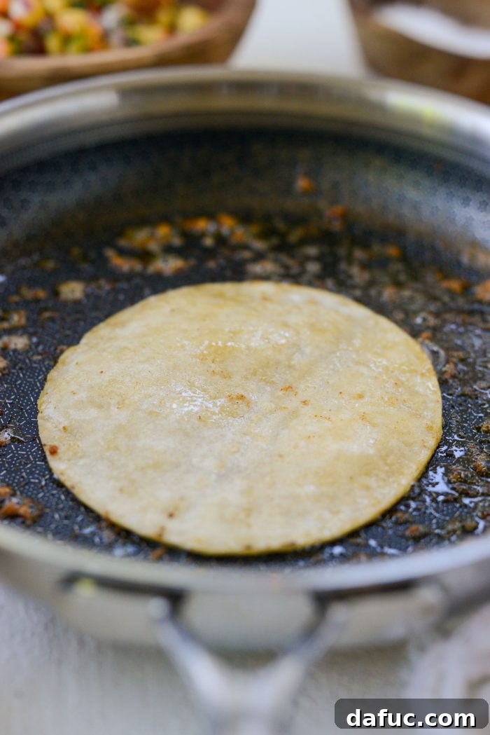 Sunshine Shrimp Tacos 10 Warming corn tortillas in the same skillet