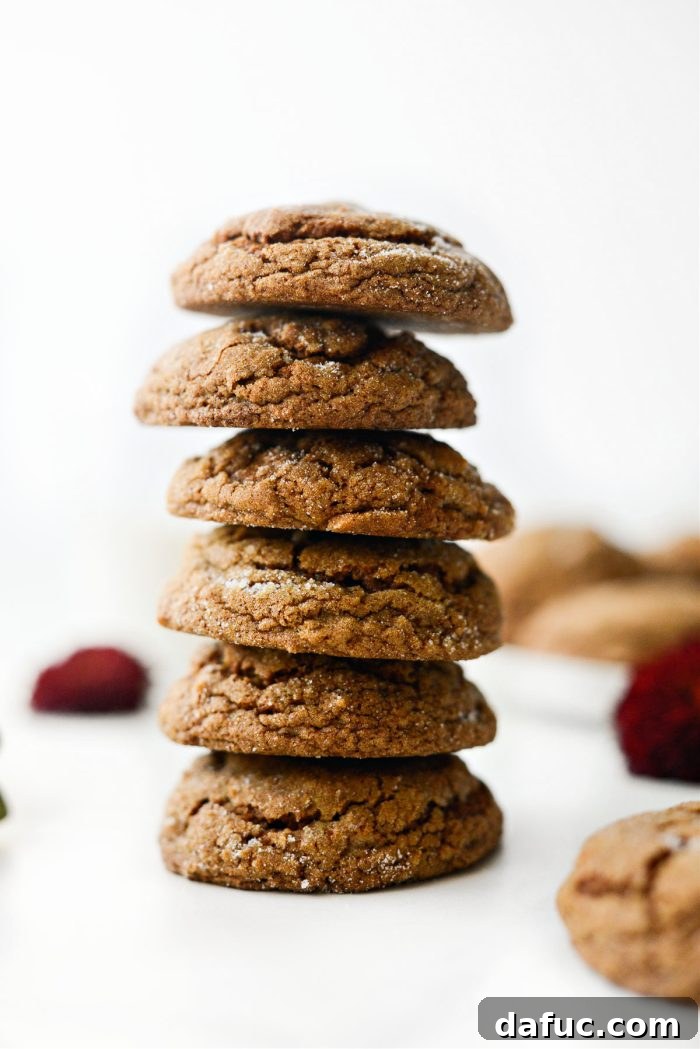 Spiced Pumpkin Molasses Chews 2 A tall stack of freshly baked Pumpkin Molasses Cookies, showcasing their soft, chewy texture and sugar-coated exterior.