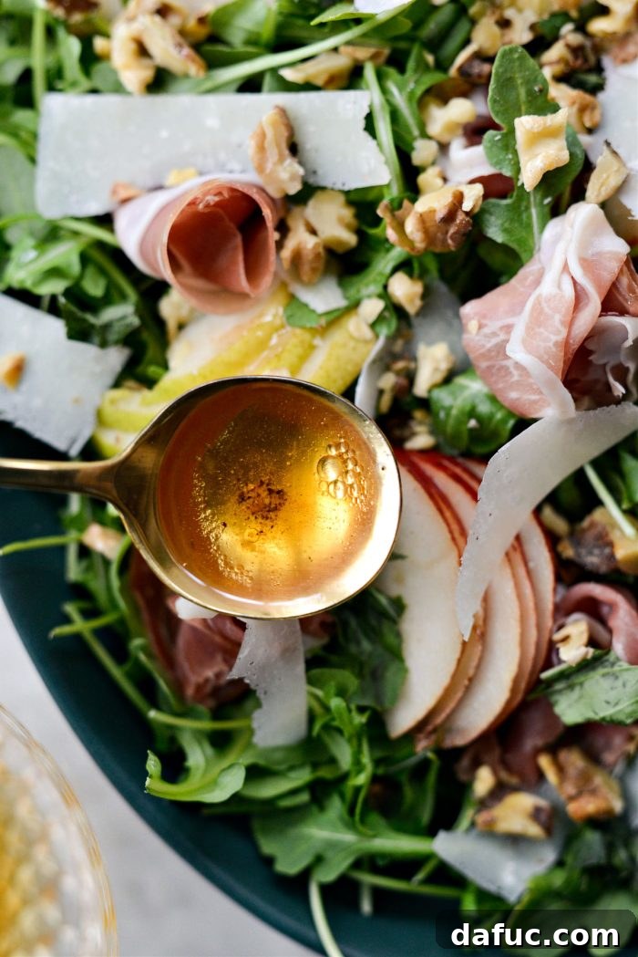 Drizzling vinaigrette over the salad