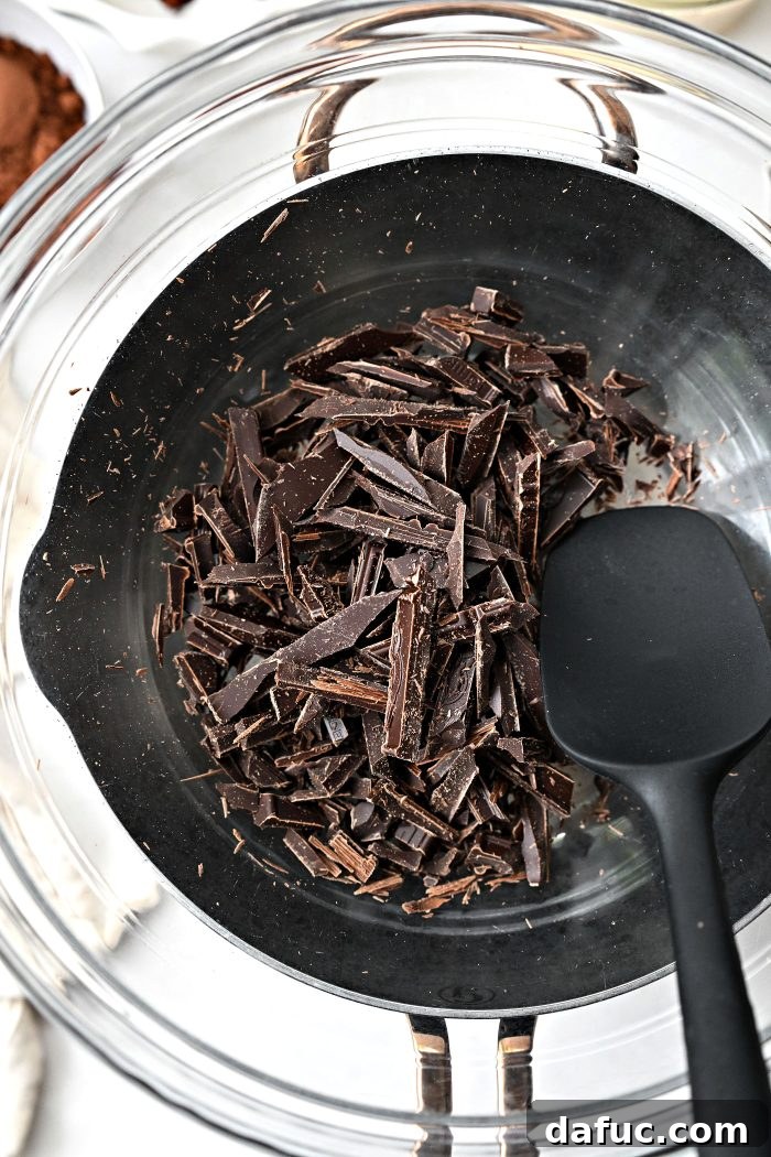chopped chocolate in bowl over saucepan